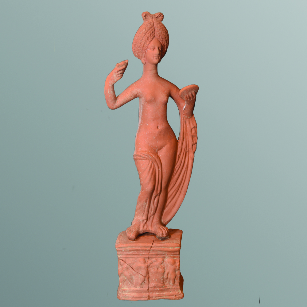 The statuette of Venus dating from the 2nd century BC was discovered in the Necropolis in 1987. The small terracotta figurine depicts Venus naked, with her clothes down. In her hands she holds a mirror and a comb. She has massive earrings in her ears. A relief with Eros is depicted on the small pedestal.