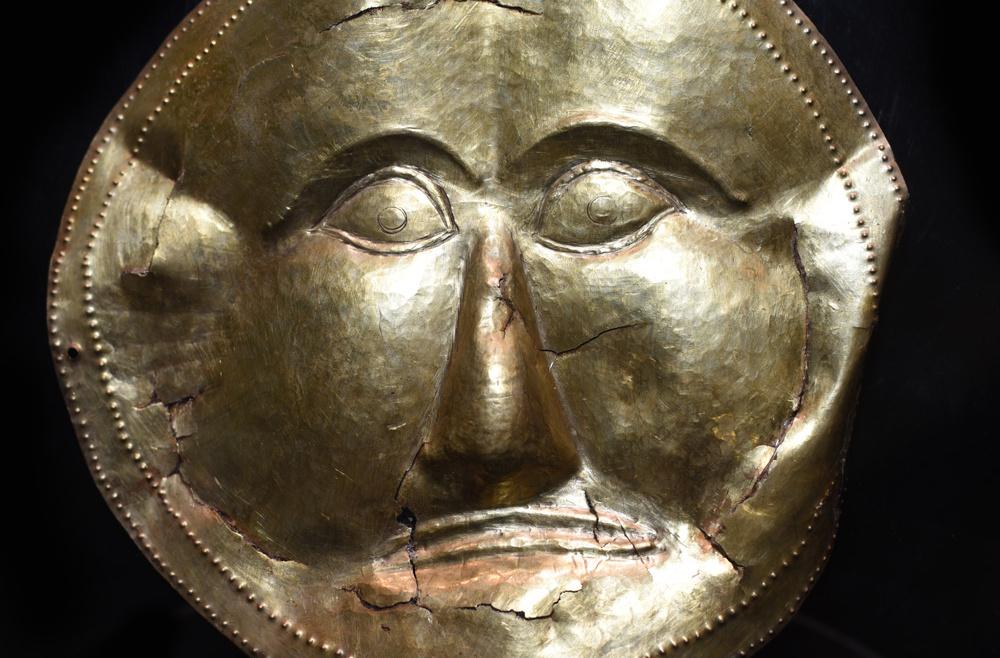 The Golden Mask from Dalakova Mogila is covered in mystery. It is strikingly reminiscent of the famous golden mask of Agamemnon of Mycenae, although there are more than 5 centuries between them. It was found during archaeological excavations of the grave of an Odrysian ruler. The buried body has been dismembered, which is a typical practice of the Orpheism and its mysteries. The funeral mask is made of a natural alloy of gold and silver called ‘electron’. The wide-open eyes are a symbol of the inner vision possessed by those initiated into the secrets of the royal institution. The look speaks of the king's divine wisdom. The ruler was considered all- seeing (omnivident) like the sun. The wide-open eyes show that the king possesses secret knowledge inaccessible to others, through which he is able to see into the beyond.