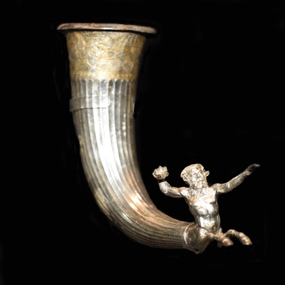 This is the only silver rhyton with a centaur found in Bulgaria. Centaurs in ancient Greek mythology were half-human and half-horse that inhabited the lands of Thrace. The human head is very expressive, tense and focused. The left hand is extended forward, and the right holds a war-ball, which the mythical creature, in his fury, is about to hurl at an imaginary adversary. The three-dimensional figure of the centaur plays the role of an apotropaeus - warding off evil forces. The rhyton from the Sliven Museum collection is a masterpiece of the Thracian art.